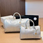 Black and gold Boston bag with front embossed CC logo, gold lock, and round leather tag-no box - Image 12