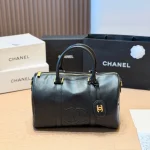 Black and gold Boston bag with front embossed CC logo, gold lock, and round leather tag-no box - Image 9
