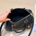 Black and gold Boston bag with front embossed CC logo, gold lock, and round leather tag-no box - Image 3