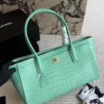 Glossy crocodile-embossed leather tote, featuring a stunning vintage gold double-C lock-box