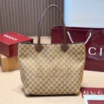 Large tote bag featuring floral canvas and red & green striped webbing, with brown leather handles-no box