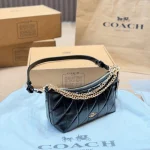 This underarm bag features shiny cowhide leather, in a classic black colorway with a metal chain-box - Image 5