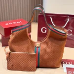 Fabric featuring the iconic green-red-green web stripe, paired with brown leather handles and a detachable shoulder strap-no box
