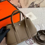 "Garden bag crafted from full-grain Togo cowhide, featuring a soft texture. Equipped with steel hardware, hand-stitched wrist strap, and original lining-box - Image 7