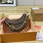 Featuring a uniquely shaped silhouette, it's also known as a moon bag-box