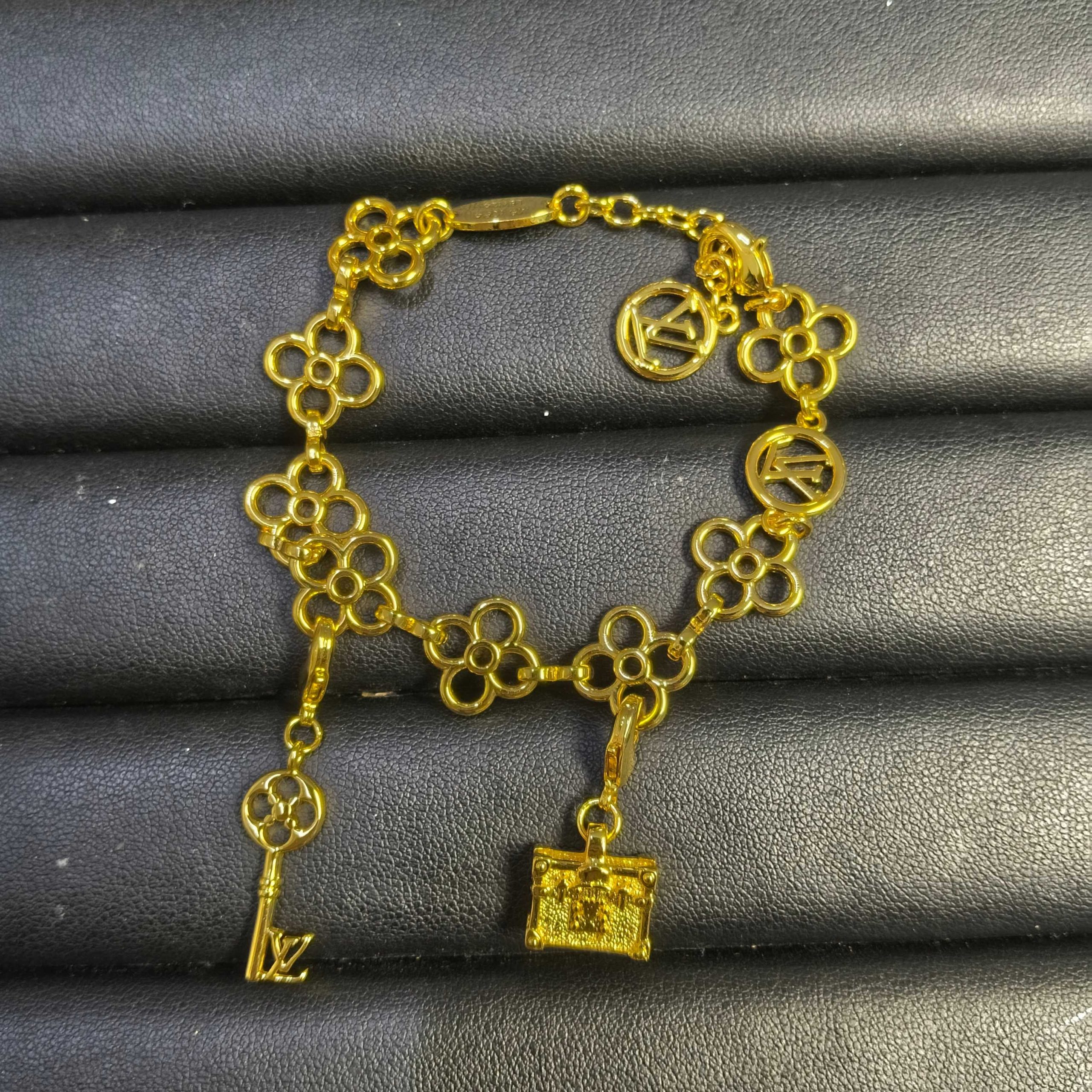 wsxc1789486927481_0 LV Openwork Monogram Flower Key & Petite Malle Charm Bracelet - Gold Tone / Silver Tone - Image 1