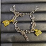 LV Keepall Bracelet: Multi-Charms with Iconic Monogram Trunk, LV Logo & Flower Pendants, Gold/Silver Tone Curb Chain - Image 7
