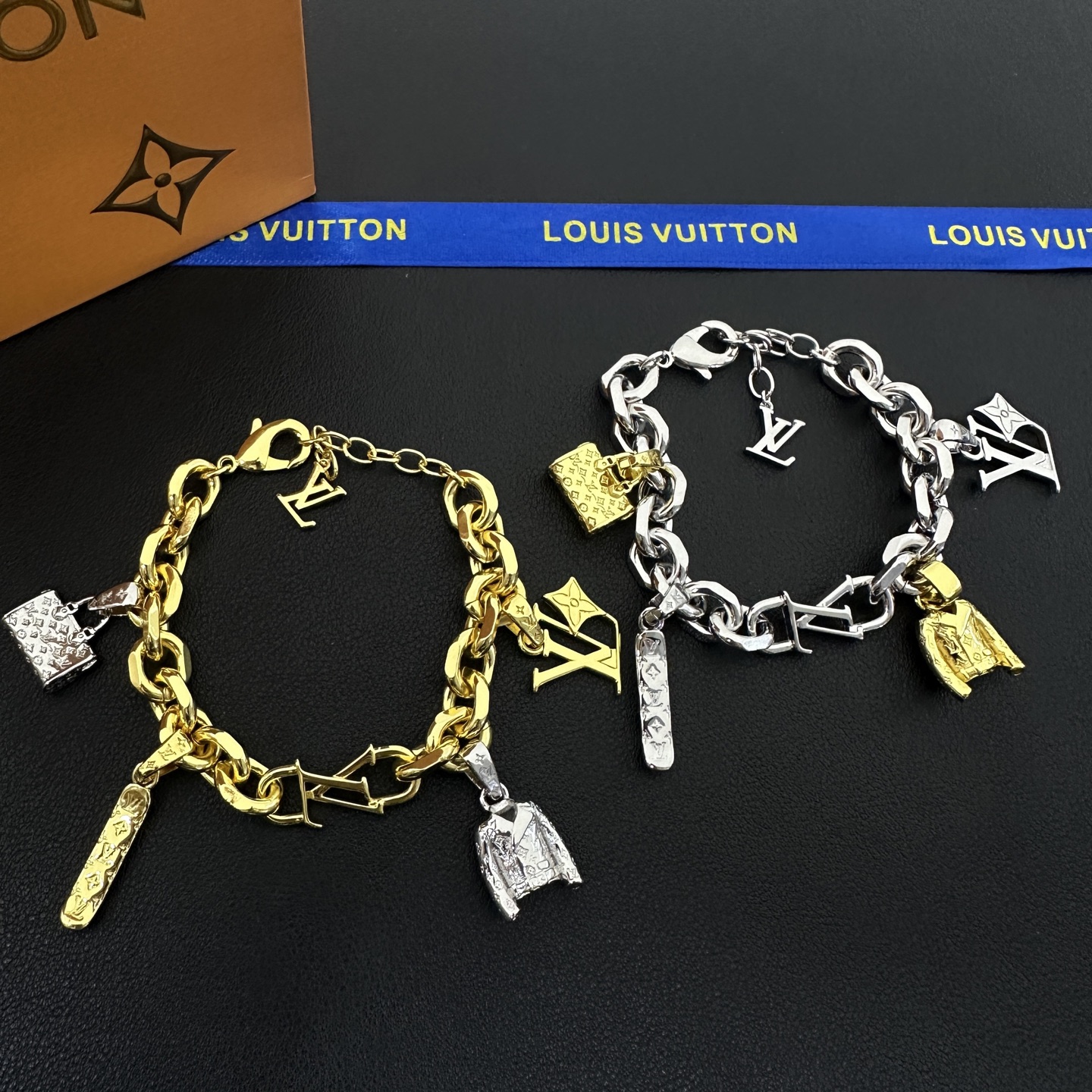 wsxc1789556139257_0 LV Keepall Bracelet: Multi-Charms with Iconic Monogram Trunk, LV Logo & Flower Pendants, Gold/Silver Tone Curb Chain - Image 1