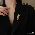 YSL Gold tone Cassandre Metal Brooch, Vintage Twisted Logo Pin, Blazer & Coat Accessory - Image 3
