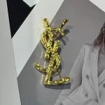 YSL Gold tone Cassandre Metal Brooch, Vintage Twisted Logo Pin, Blazer & Coat Accessory - Image 4