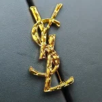 YSL Gold tone Cassandre Metal Brooch, Vintage Twisted Logo Pin, Blazer & Coat Accessory - Image 5