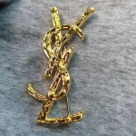 YSL Gold tone Cassandre Metal Brooch, Vintage Twisted Logo Pin, Blazer & Coat Accessory